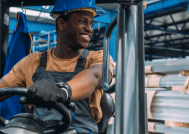 Worker operating forklift